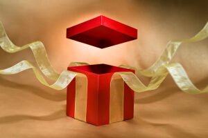A red and gold gift box with a ribbon around it.